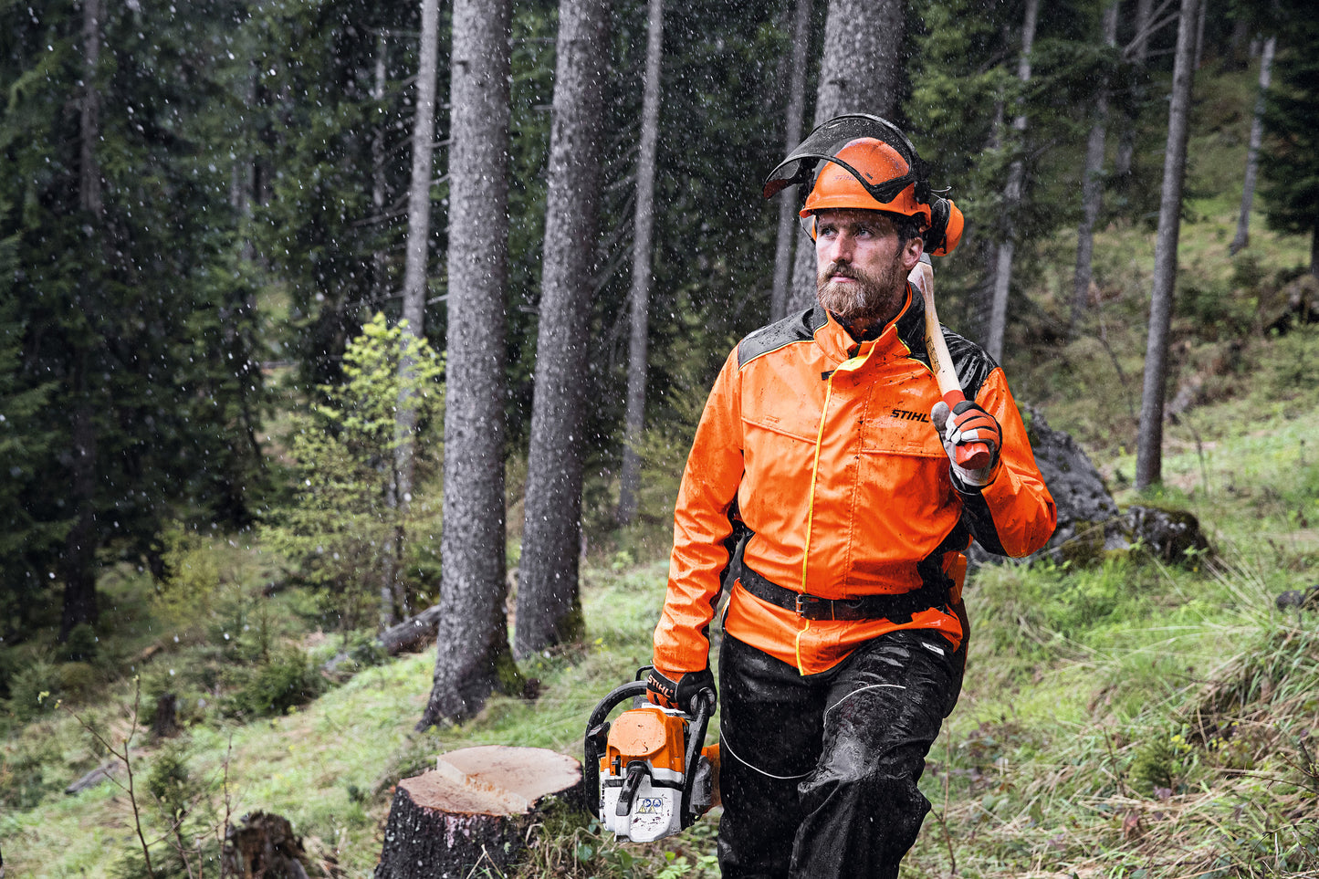 Giacca impermeabile Stihl Duroflex arancione ad alta visibilità in uso in ambiente forestale