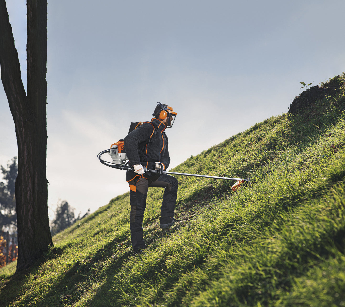 Operatore con decespugliatore a zaino Stihl FR 410 C-E su pendio per sfalcio erba
