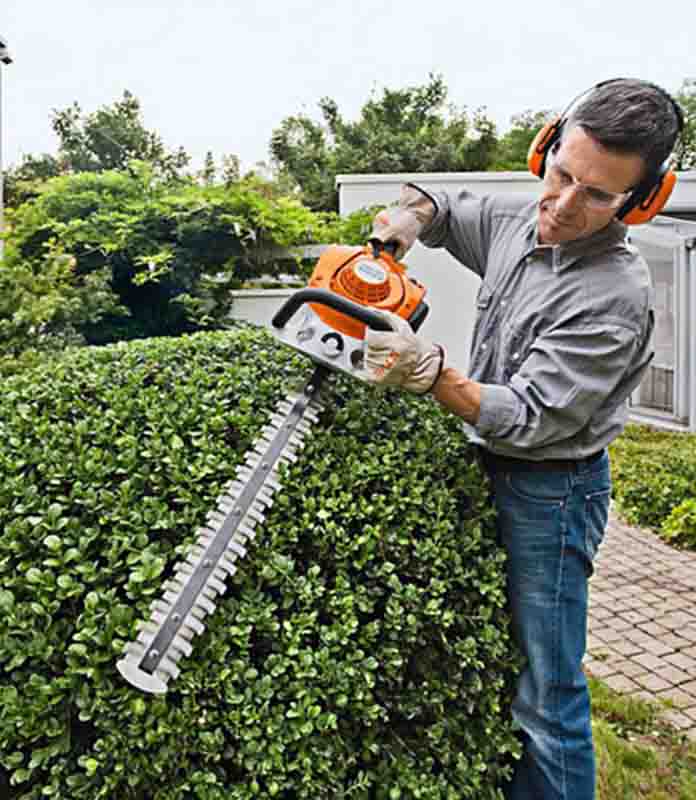 Operatore che utilizza tagliasiepe Stihl HS 46 su siepe